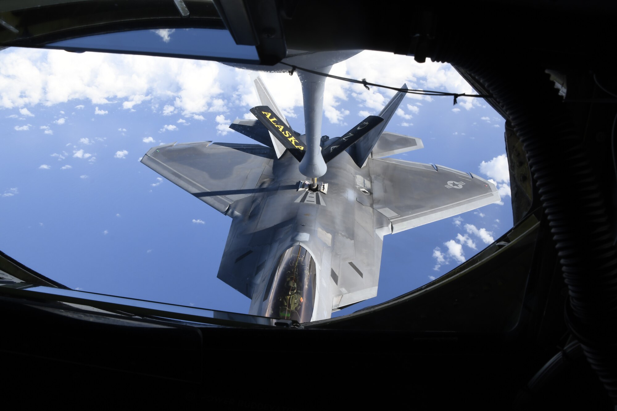 A U.S Air Force KC-135 Stratotanker assigned to the 168th Wing, Alaska, refuels a F-22 Raptor assigned to the 3rd Wing, Joint Base Elmendorf-Richardson, Alaska, over the Pacific Ocean.