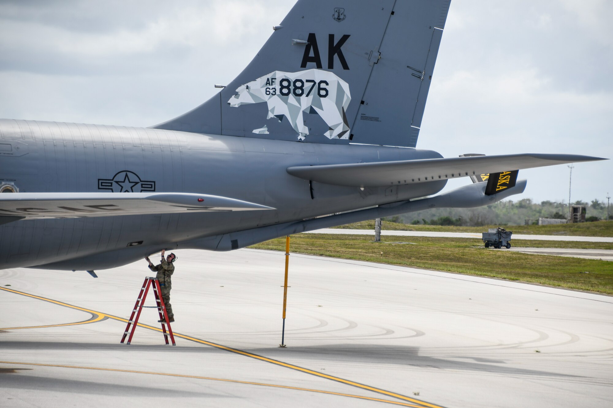 A U.S. Air National Guard Airman assigned to the 168th Wing Maintenance Group prepares to remove a panel, inspect, and conduct maintenance on an Alaska Air National Guard KC-135 Stratotanker.