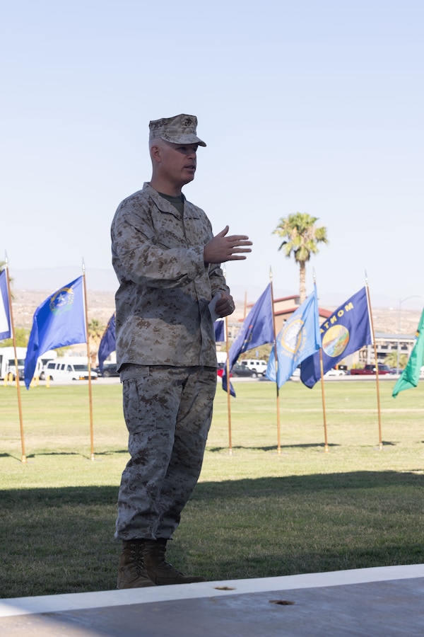 U.S. Marine Corps Col. Patrick Reynolds, a Bronx, New York native, outgoing commanding officer of Marine Corps Logistics and Operations Group, Marine Air-Ground Task Force Training Command, Marine Corps Air-Ground Combat Center, gives a speech during a change of command ceremony at Lance Corporal Torrey Grey Field, MCAGCC, Twentynine Palms, California, June 21, 2024. The change of command ceremony represents the official passing of command from Reynolds to Col. Leonel Brito Jr. (U.S. Marine Corps photo by Lance Cpl. Anna Higman)