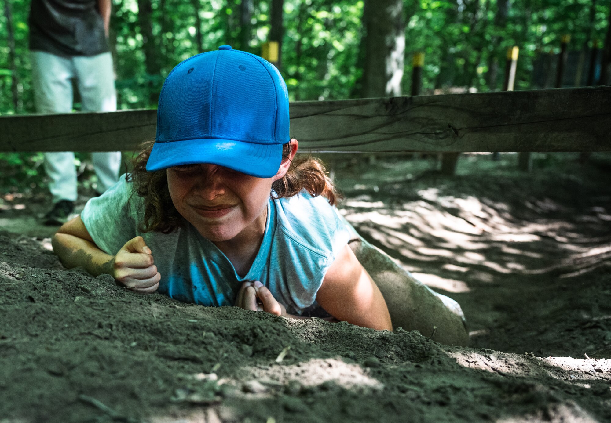 a cadet crawls through dirt