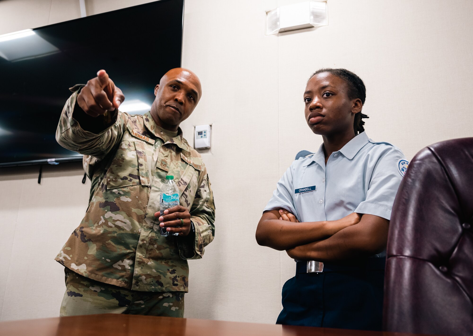 Military member points during a discussion with a cadet