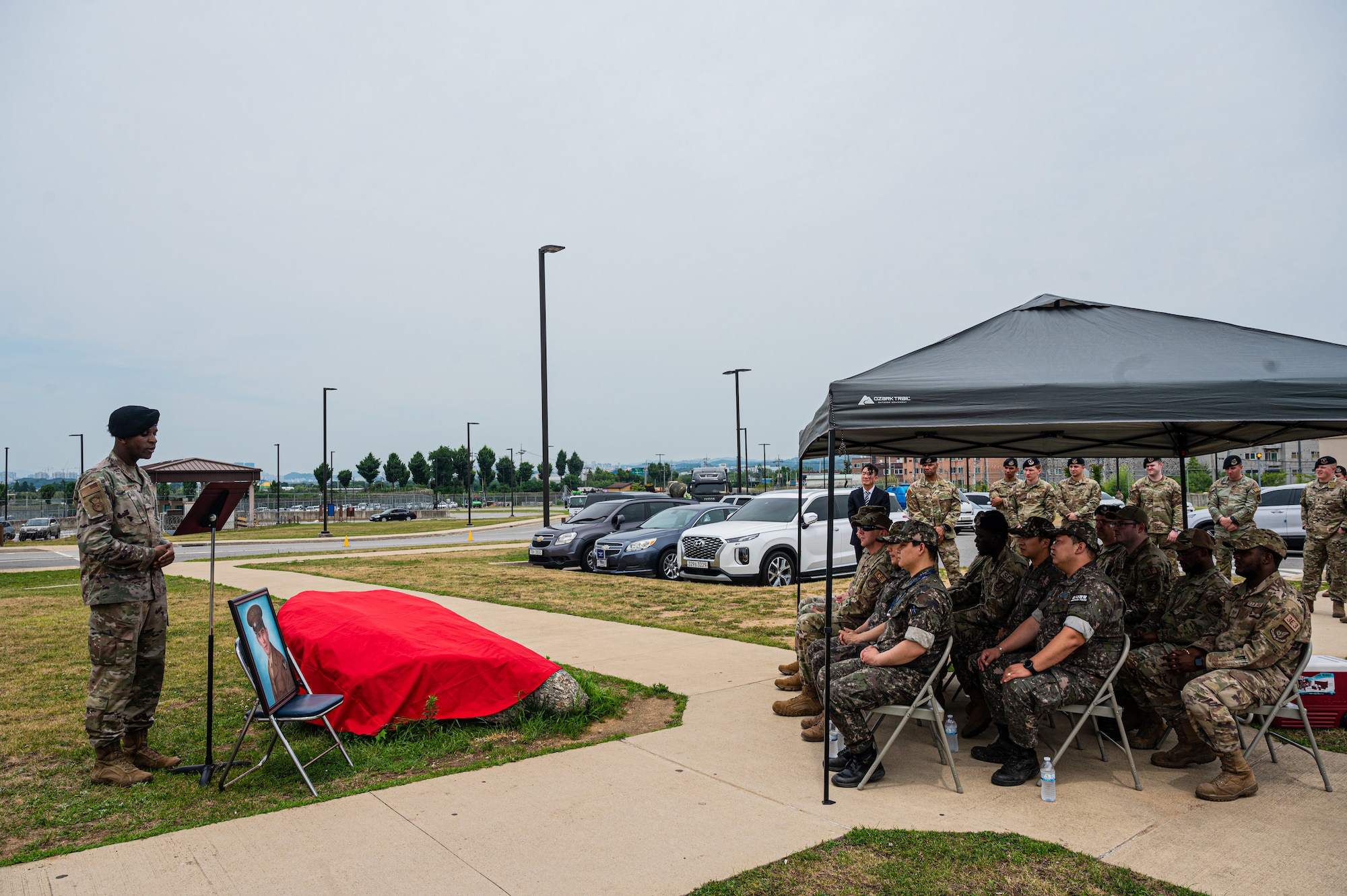 U.S. Air Force Staff Sgt. Ian Kelley, 51st Security Forces Squadron evaluator, speaks at a rededication ceremony for Corporal  Joseph Morin at Osan Air Base, Republic of Korea, June 27, 2024. Morin was the first Air Police member killed in action after the inception of the U.S. Air Force on September 18, 1947. (U.S. Air Force photo by Staff Sgt. Christopher Tam)