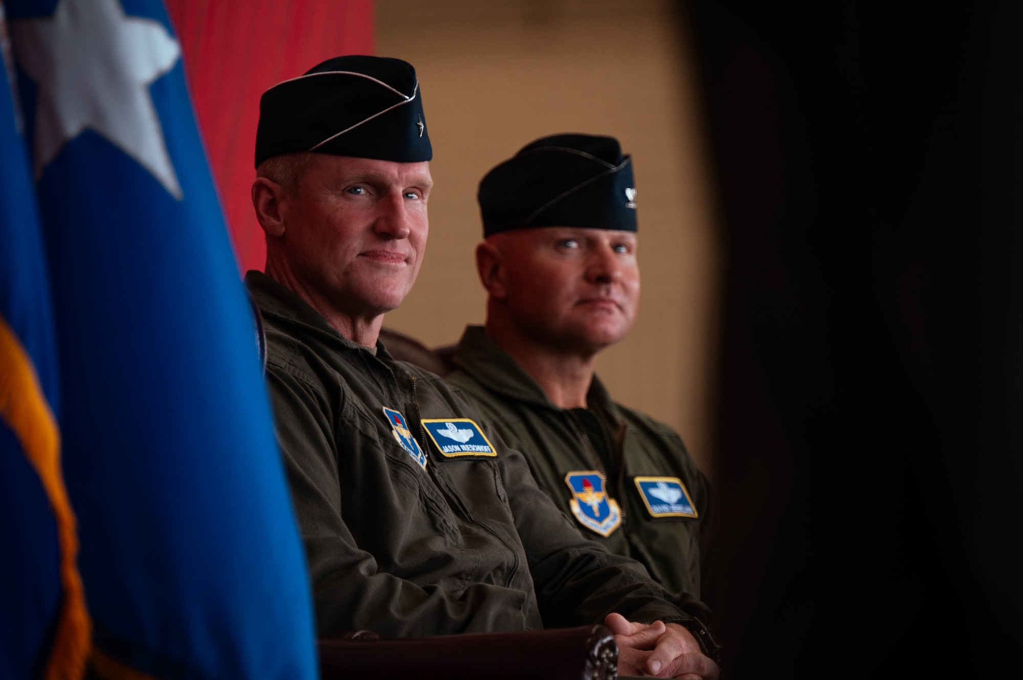 U.S. Air Force Brig. Gen. Jason Rueschhoff (left), 56th Fighter Wing outgoing commander, sits with Col. David Berkland (right), 56th FW incoming commander, at the 56th FW Change of Command ceremony, July 1, 2024, at Luke Air Force Base, Arizona.