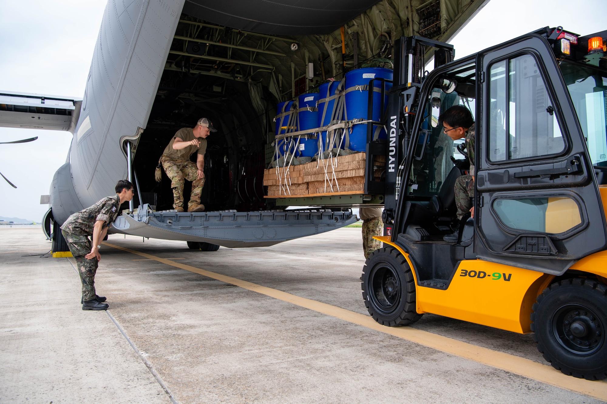 U.S. Air Force Senior Airman Carson Christian, 36th Airlift Squadron loadmaster, and members of the Republic of Korea Air Force load container delivery system bundles onto a C-130J Super Hercules assigned to the 36th AS in preparation for an airdrop training event at Gimhae Air Base, Republic of Korea.