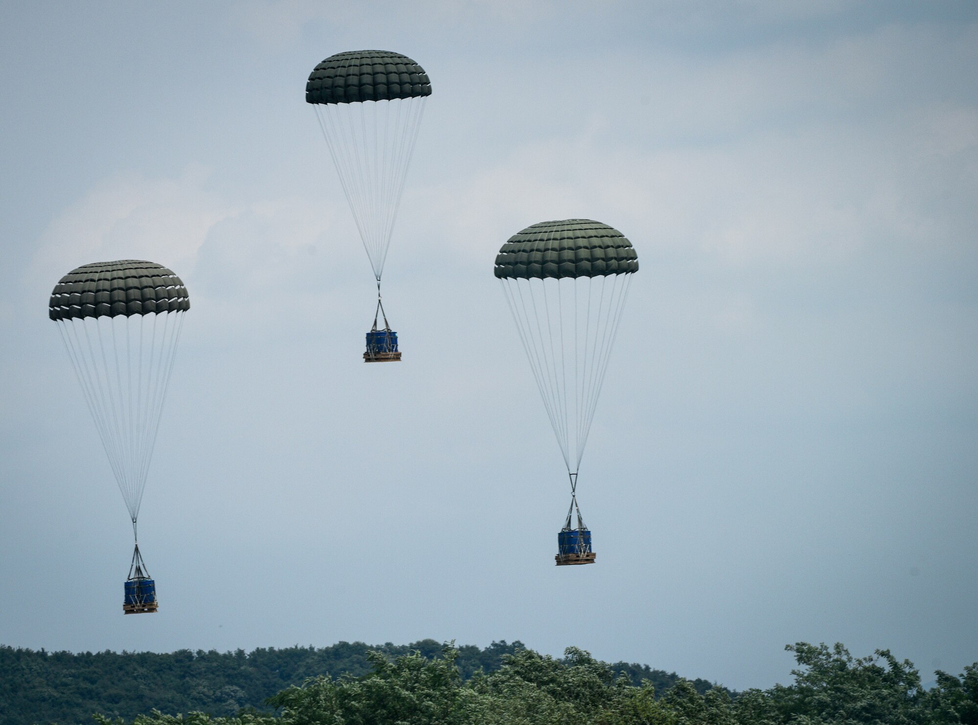 Pallets dropped by a U.S. Air Force C-130J Super Hercules assigned to the 374th Airlift Wing, Yokota Air Base, Japan, land in a designated landing zone during a combined Republic of Korea and U.S. cargo drop training event near Yeoju, Republic of Korea.