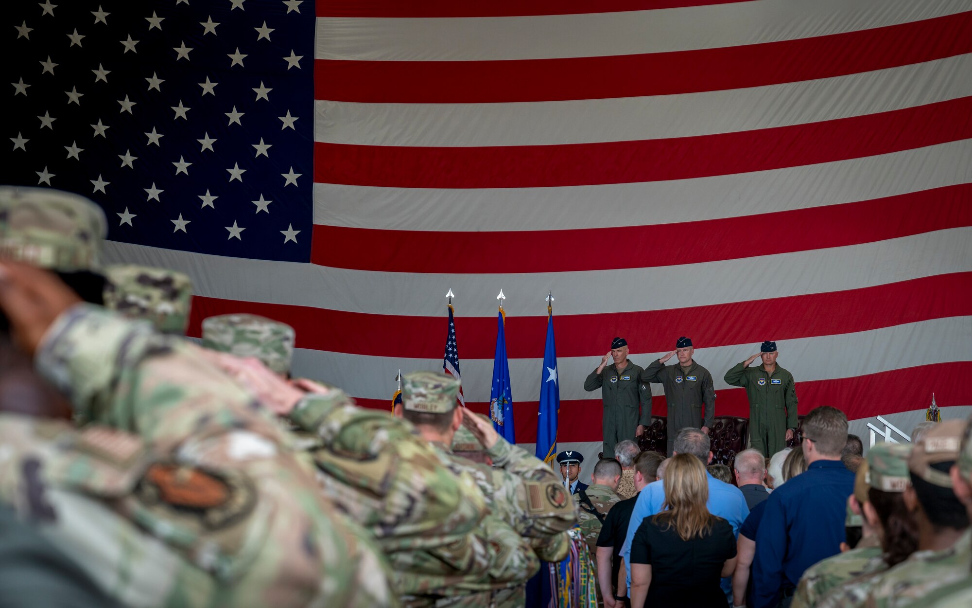 U.S. Air Force Maj. Gen. Clark J. Quinn (left), 19th Air Force commander, Brig. Gen. Jason Rueschhoff (center), 56th Fighter Wing outgoing commander, and Col. David Berkland (right), 56th FW incoming commander, salute during the 56th FW Change of Command ceremony, July 1, 2024, at Luke Air Force Base, Arizona.