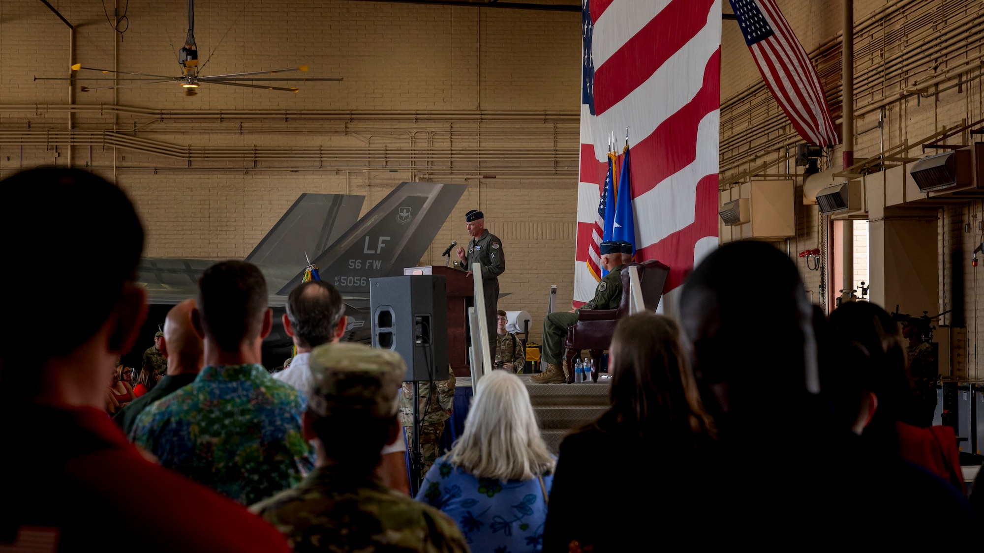 U.S. Air Force Maj. Gen. Clark J. Quinn (center), 19th Air Force commander, speaks during the 56th Fighter Wing Change of Command ceremony, July 1, 2024, at Luke Air Force Base, Arizona.