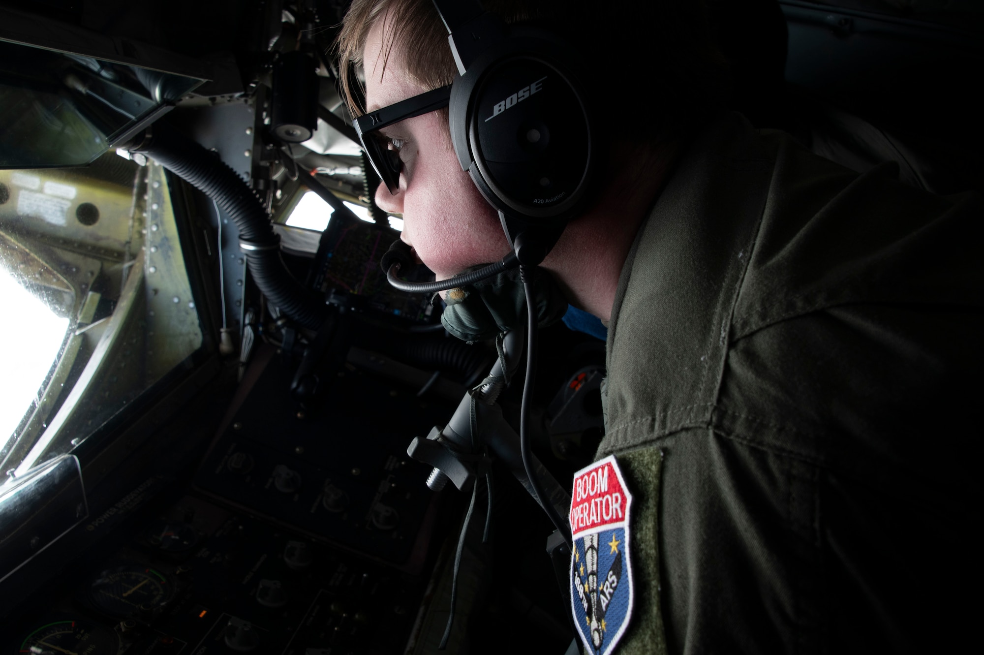 U.S. Air Force Senior Airman Gage Frohnapfel, Alaska Air National Guard KC-135 Stratotanker boom operator, conducts aerial refueling operations