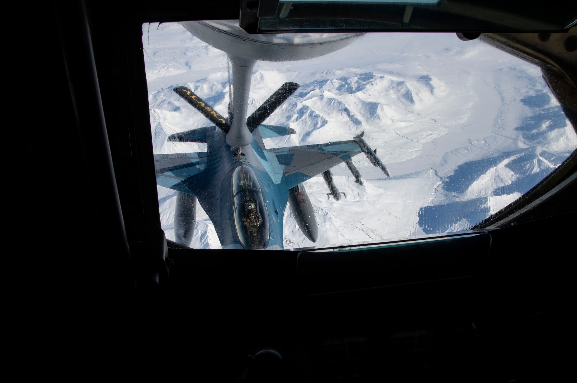 An F-16 flies over the Pacific Alaska Range Complex in Alaska to meet up with the 168th Wing KC-135 Stratotanker for air refueling.