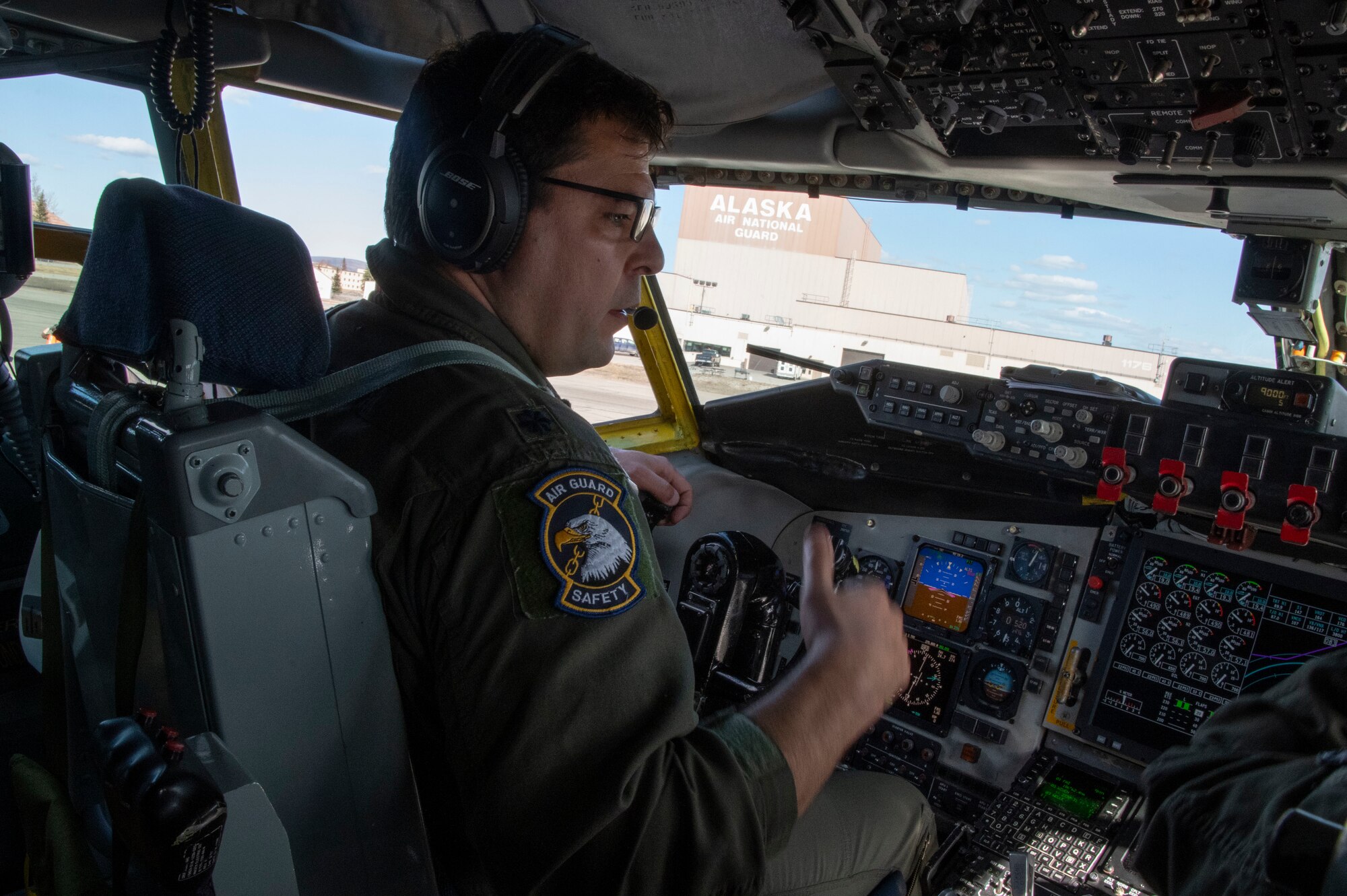 U.S. Air Force Lt. Col. Joe Bob Howard, a pilot with the 168th Wing, Alaska Air National Guard, talks over the radio and operates a KC-135 Stratotanker.