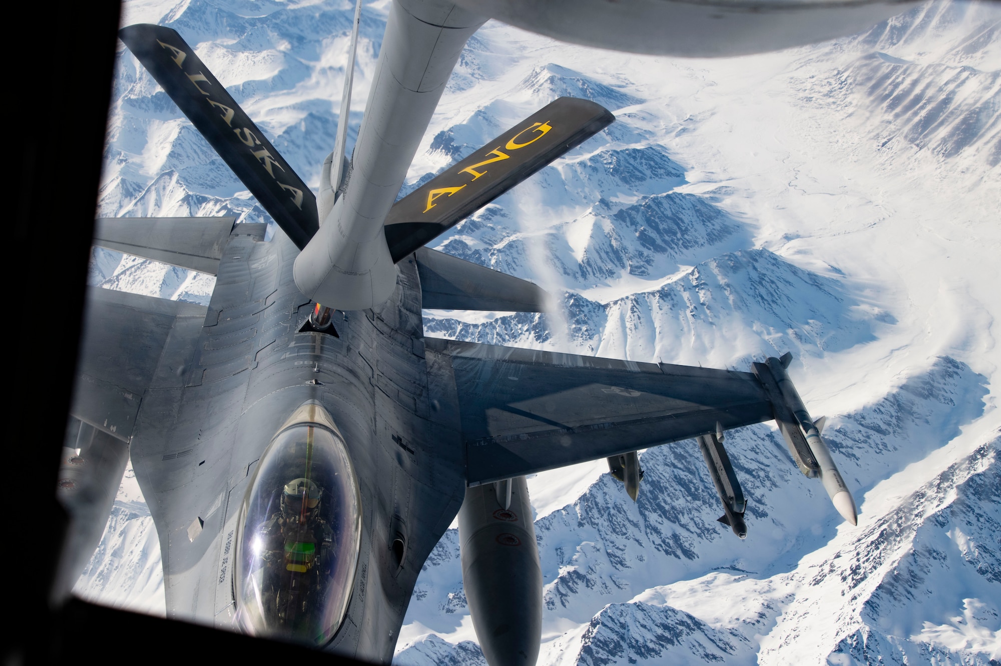 A U.S. F-16 Fighting Falcon approaches the boom of a 168th Wing KC-135 Stratotanker during Red Flag Alaska 24-1 aerial refueling operations over Alaska.