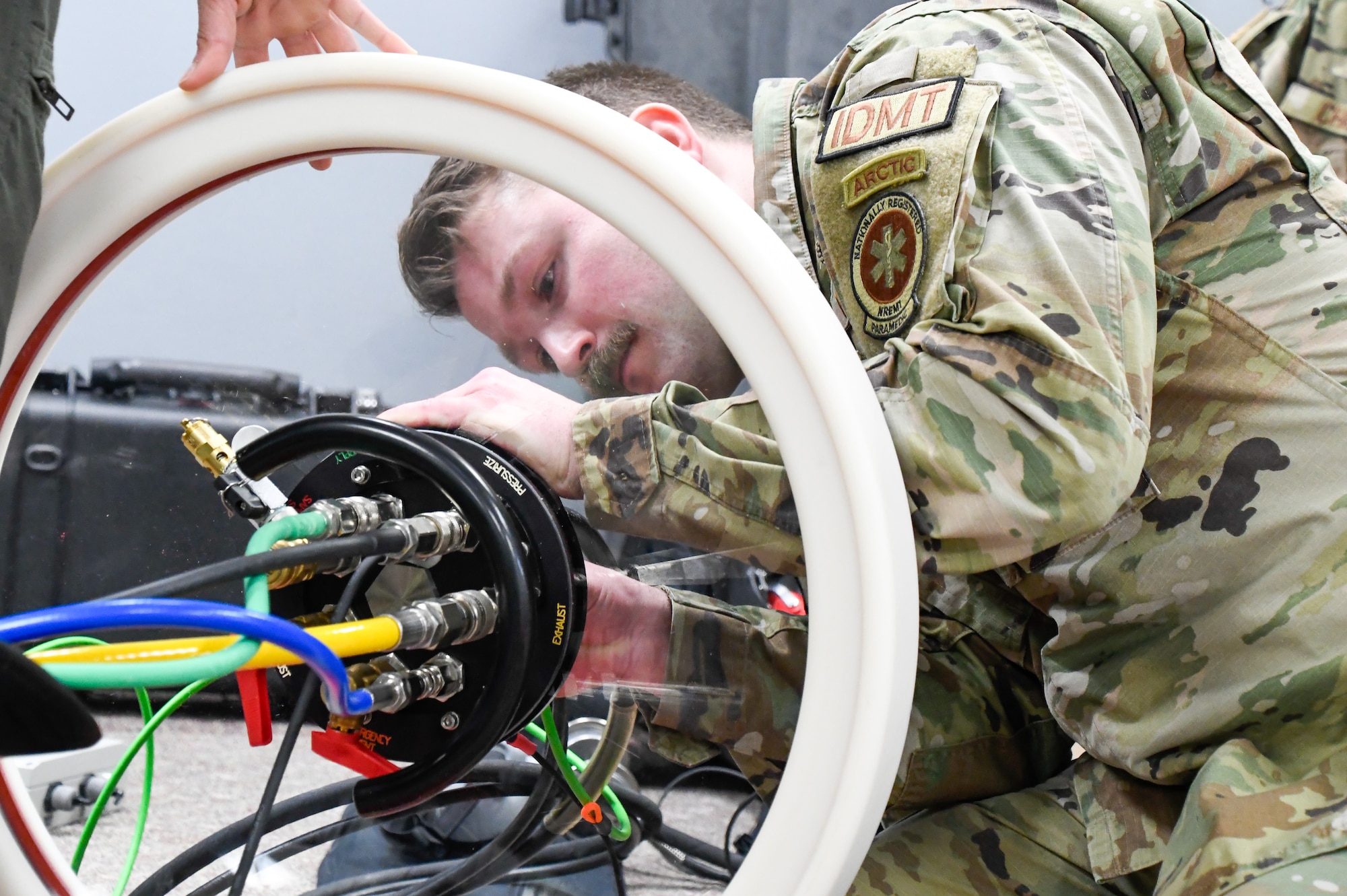 Airmen of the 354th Medical Group set up a portable decompression sickness chamber during a training exercise simulating an emergency for a patient requiring oxygen therapy, utilizing the hyperbaric stretcher on board the 168th Wing KC-135.