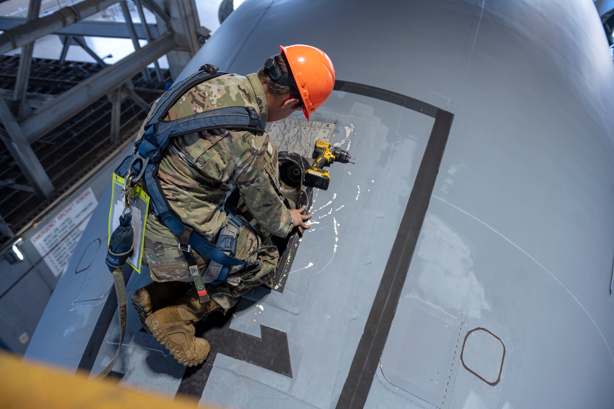 airman checks the panel for a port receiver on a KC-10 Extender