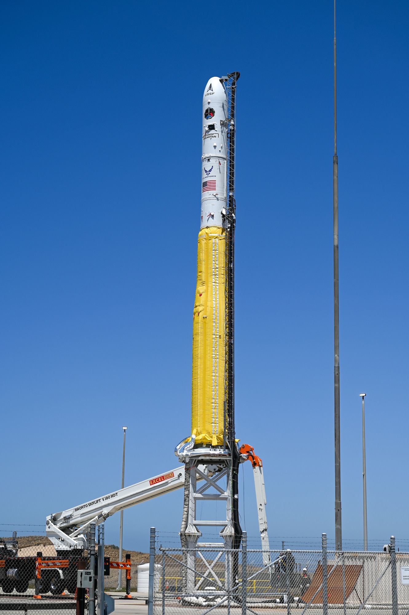 A rocket sits on a launch pad.