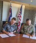 Commodore Shane Glassock, the director general for Logistics Operations Branch at the Joint Logistics Command and Maj. Gen. Jered Helwig, the commanding general of the 8th Theater Sustainment Command, signed a logistics letter of intent to establish the care of supplies in storage for U.S. Army equipment in Bandiana, Australia May 21, 2024.