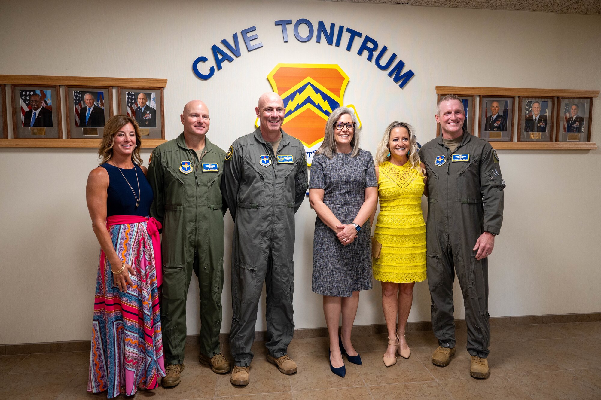 Arizona Governor Katie Hobbs (center right) stands alongside U.S. Air Force Maj. Gen. Clark Quinn (center left), 19th Air Force commander, Brig. Gen. Jason Rueschhoff (far right), 56th Fighter Wing outgoing commander, his wife Melissa Rueschhoff (second from right), Col. David Berkland (second from left), incoming 56th FW commander, and his wife Nikki Berkland (far left), for a group photo, July 1, 2024, at Luke Air Force Base, Arizona.