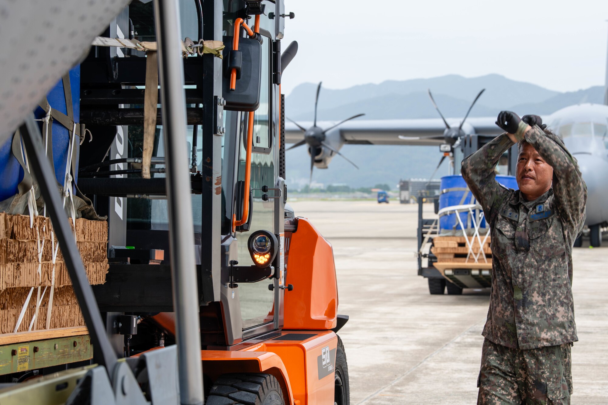 A member of the Republic of Korea Air Force loads container delivery system bundles onto a C-130J Super Hercules assigned to the 36th Airlift Squadron in preparation for an airdrop training event at Gimhae Air Base, Republic of Korea.