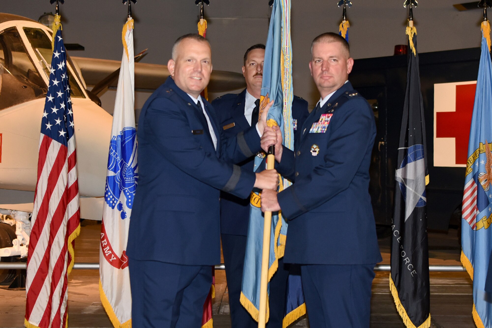 Leaders pass the guidon during a change of command ceremony