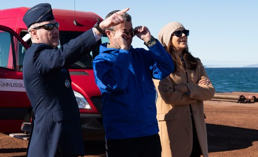  From the left, U.S. Space Force Col. Jason Terry, 821st Space Base Group commander, King Frederik X, King of the Kingdom of Denmark, and Queen Mary, Queen of the Kingdom of Denmark, look ahead at Mount Dundas on the outskirts of Pituffik Space Base, Greenland, June 29, 2024. Located only miles from Pituffik SB, Mount Dundas served as a base camp for polar expeditions in the late 19th century and into the 20th century. (U.S. Space Force photo by 1st Lt. Danielle Rose)