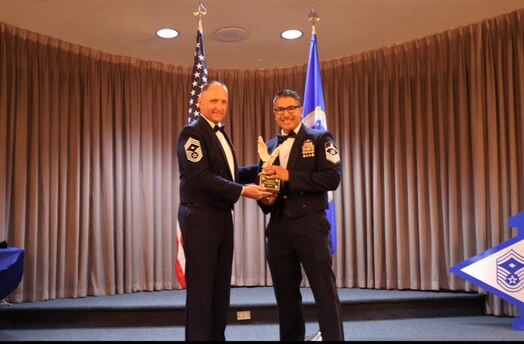  Individual accepts military award on stage