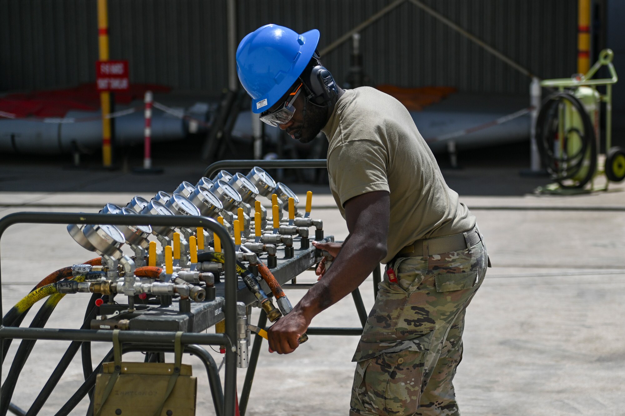 Airman turns air pressure valves