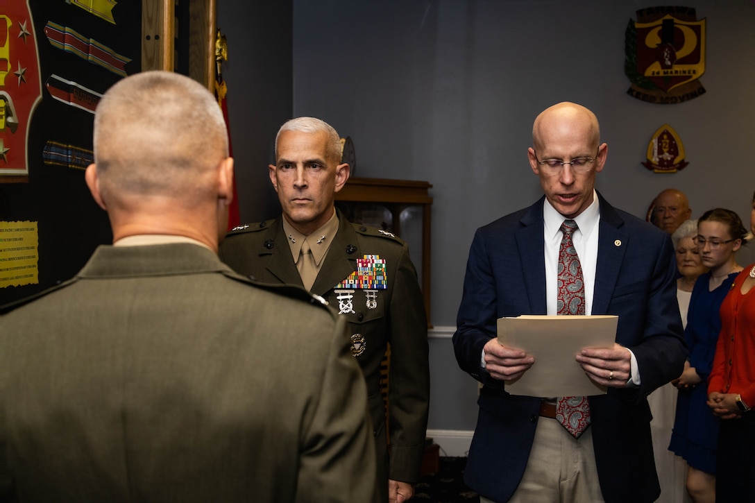 A retired U.S. Marine veteran reads a promotion warrant during a frocking ceremony for Col. James W. Lively on Marine Corps Base Camp Lejeune, North Carolina, June 30, 2024. Frocking is a tradition where Marines are advanced to the next pay grade, assuming the title and the responsibilities prior to their official date of promotion. Lively, the assistant division commander of 2d Marine Division, was frocked to the rank of brigadier general. (U.S. Marine Corps photo by Sgt. Alexa M. Hernandez)
