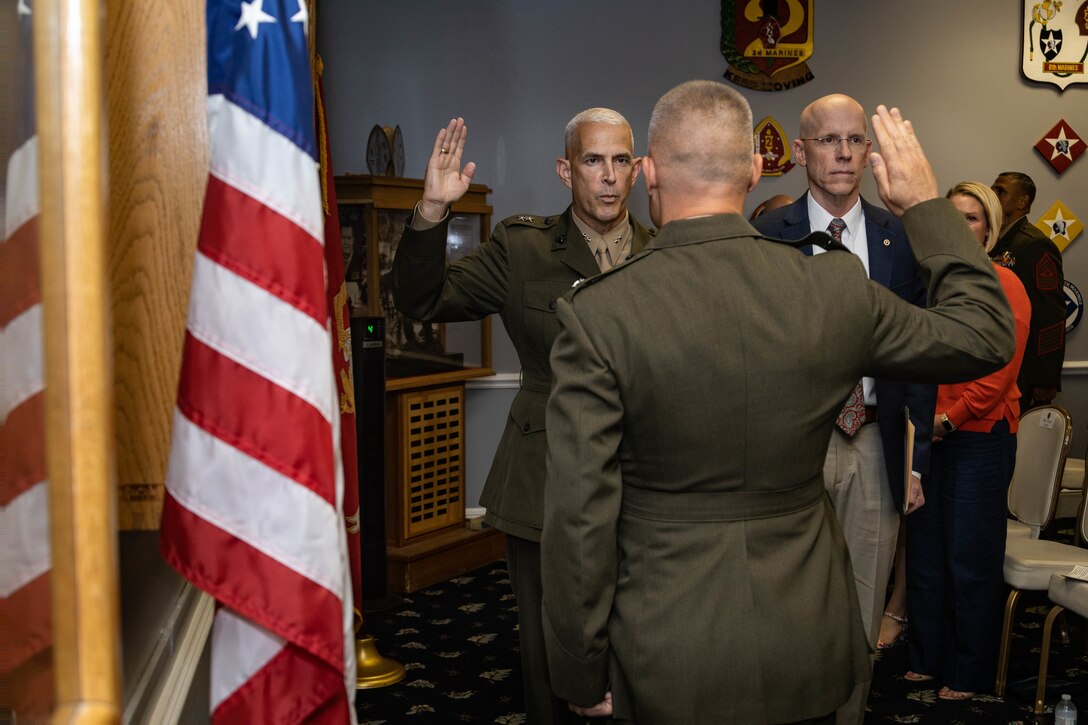 U.S. Marine Corps Maj. Gen. David L. Odom, left, the commanding general of 2d Marine Division (MARDIV), recites the Oath of Office during Col. James W. Lively’s frocking ceremony on Marine Corps Base Camp Lejeune, North Carolina, June 30, 2024. Frocking is a tradition where Marines are advanced to the next pay grade, assuming the title and the responsibilities prior to their official date of promotion. Lively, the assistant division commander of 2d MARDIV, was frocked to the rank of brigadier general. (U.S. Marine Corps photo by Sgt. Alexa M. Hernandez)