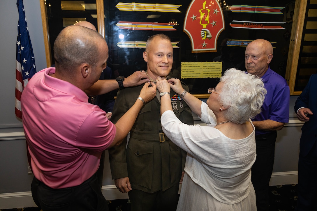 U.S. Marine Corps Col. James W. Lively, center, the assistant division commander of 2d Marine Division, is pinned by family and friends during his frocking ceremony on Marine Corps Base Camp Lejeune, North Carolina, June 30, 2024. Frocking is a tradition where Marines are advanced to the next pay grade, assuming the title and the responsibilities prior to their official date of promotion. Lively was frocked to the rank of brigadier general. (U.S. Marine Corps photo by Sgt. Alexa M. Hernandez)