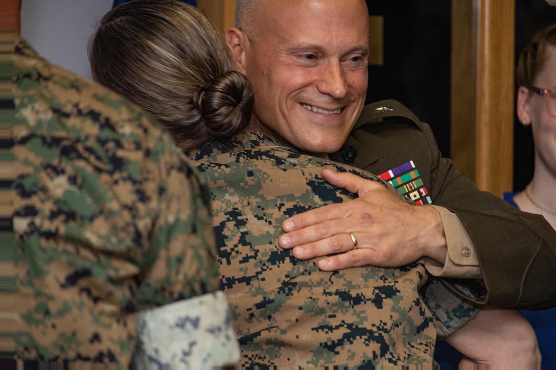 U.S. Marine Corps Col. James W. Lively, the assistant division commander of 2d Marine Division, hugs a Marine during his frocking ceremony on Marine Corps Base Camp Lejeune, North Carolina, June 30, 2024. Frocking is a tradition where Marines are advanced to the next pay grade, assuming the title and the responsibilities prior to their official date of promotion. Lively was frocked to the rank of brigadier general. (U.S. Marine Corps photo by Sgt. Alexa M. Hernandez)