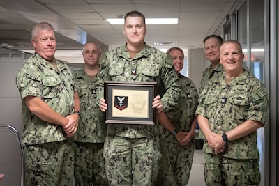 Hospital Corpsman Third Class Joseph Kitchin, center, stand with leadership from Naval Health Clinic Cherry Point after his promotion Monday, July 1.