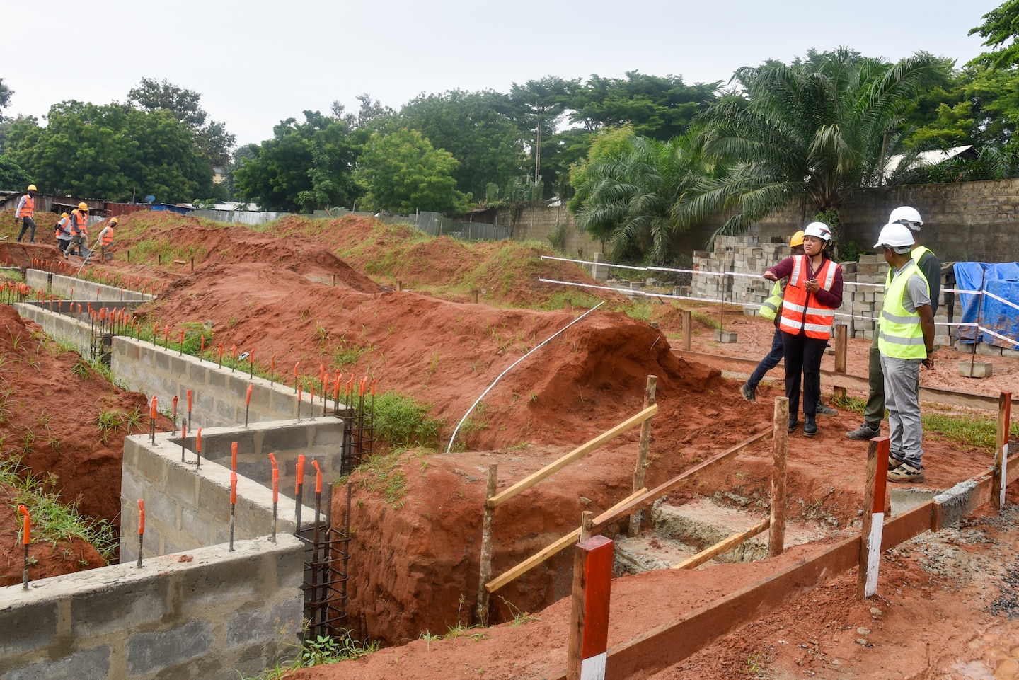 U.S. Army Corps of Engineers, Europe District Special Projects Resident Engineer Angela Tugaoen discusses progress with contractors on the new National Emergency Operations Center being constructed in Lomé, Togo Wednesday June 26, 2024. Europe District is managing the project in close partnership and coordination with the U.S. Embassy in Togo, Togolese partners, the North Dakota National Guard and others. (U.S. Army photo by Chris Gardner)