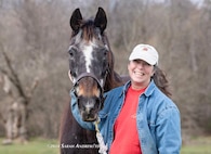 Julie Izzo is pictured with her thoroughbred, Axl, the world’s oldest known living former racehorse at 38 years old. Izzo and her husband, Carmine, a retired 21-year Army veteran, have owned Axl since he was 7 years old. (Sarah K. Andrew/Thoroughbred Daily News)