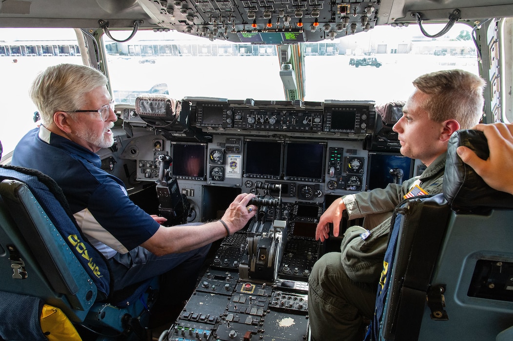 U.S. Air Force 1st Lt. Andrew Brabant, right, 3rd Airlift Squadron C-17 Globemaster III pilot, answers questions from Dan Taylor, left, Team Dover honorary commander, on the flight deck at Dover Air Force Base, Delaware, June 27, 2024. Team Dover honorary commanders and commander’s council members visited 436th Mission Generation Group units, interacted with Airmen and toured a C-17 to learn more about the 436th MGG mission. (U.S. Air Force photo by Roland Balik)