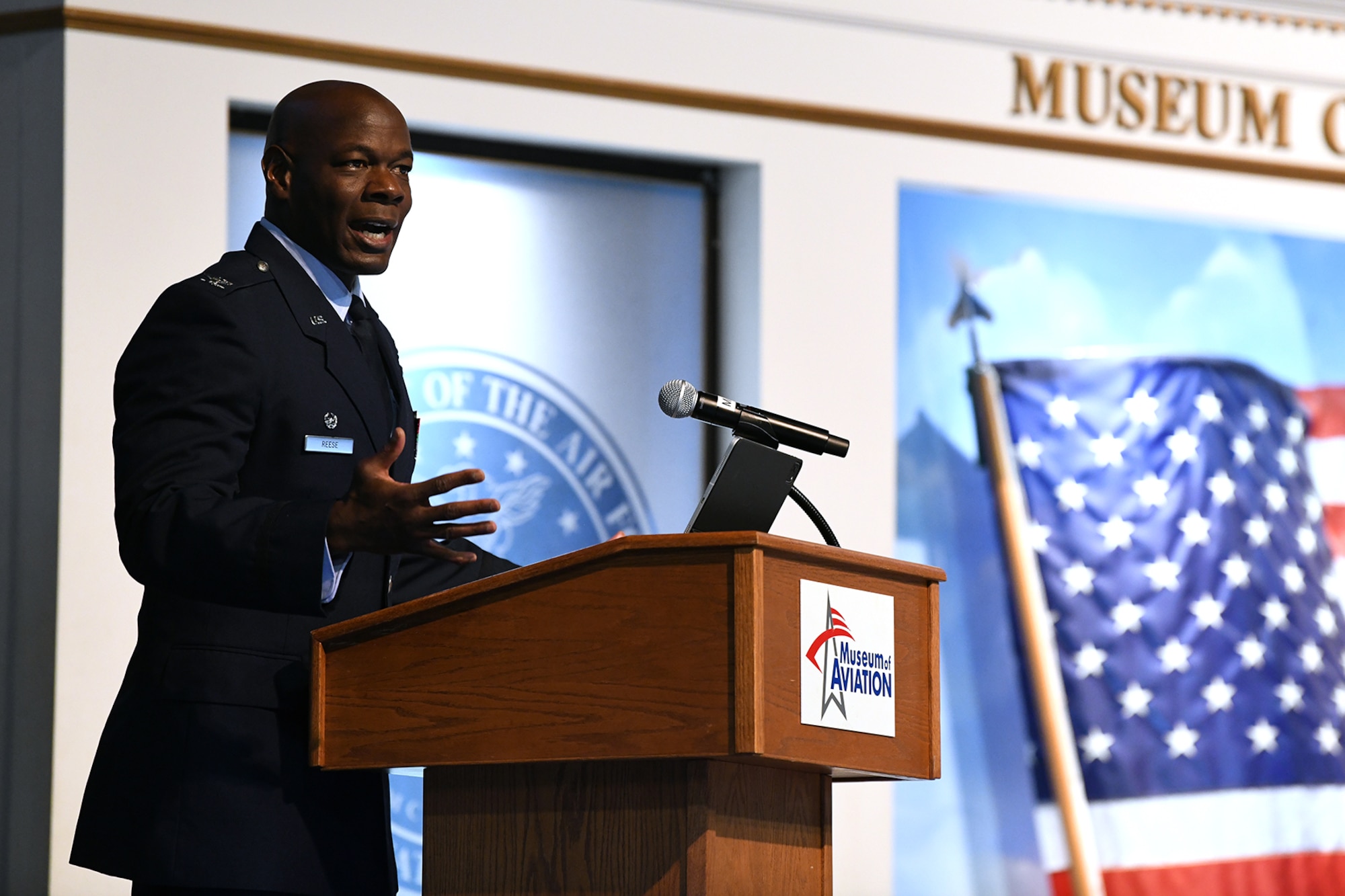 Man in military uniform speaking at a podium