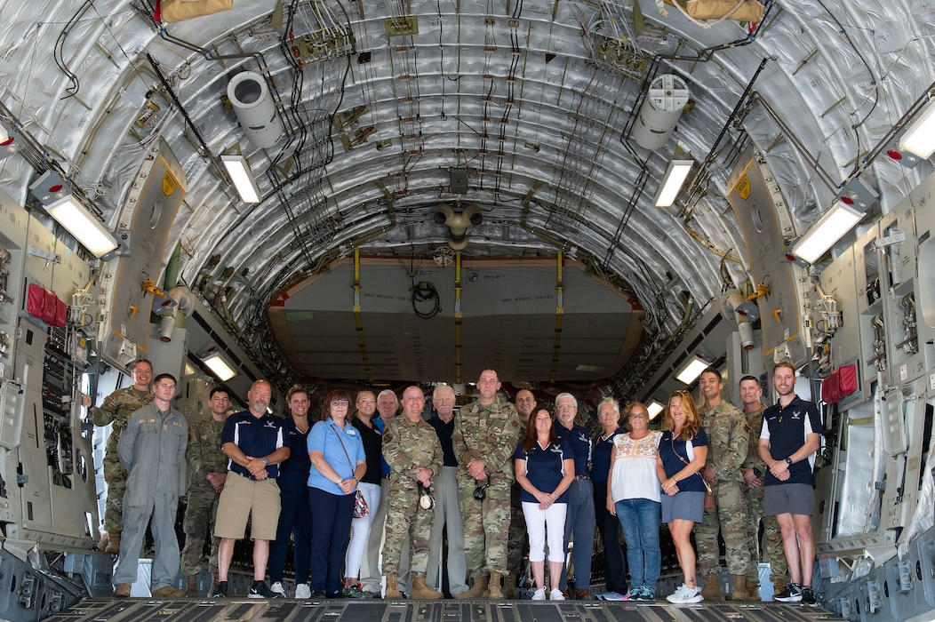 Team Dover Airmen, honorary commanders and commander’s council members pose for a photo in the cargo compartment of a C-17 Globemaster III at Dover Air Force Base, Delaware, June 27, 2024. During their tour, the honorary commanders and commander’s council members visited 436th Mission Generation Group units and interacted with Airmen to learn more about the 436th MGG mission. (U.S. Air Force photo by Roland Balik)