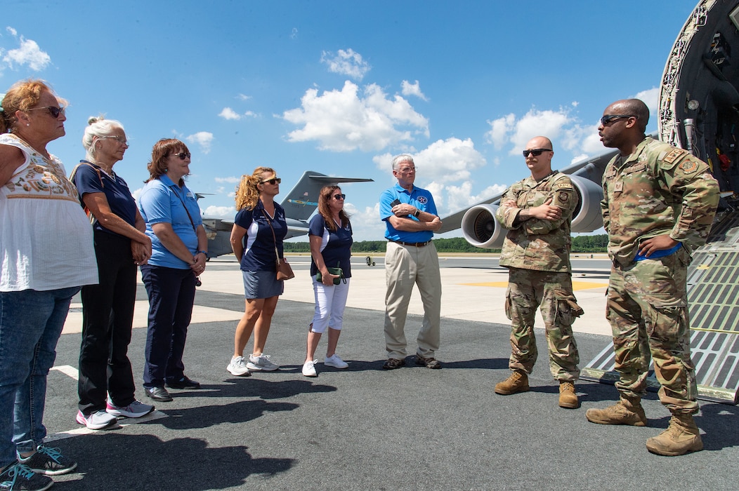 U.S. Air Force Tech. Sgt. Dnetric Gatling, right, and Staff Sgt. Bailey Doolittle, second right, both 436th Aircraft Maintenance Squadron C-5M Super Galaxy crew chiefs, answer questions from Team Dover honorary commanders and commander’s council members at Dover Air Force Base, Delaware, June 27, 2024. During their tour, the honorary commanders and commander’s council members visited 436th Mission Generation Group units and interacted with Airmen to learn more about the 436th MGG mission. (U.S. Air Force photo by Roland Balik)