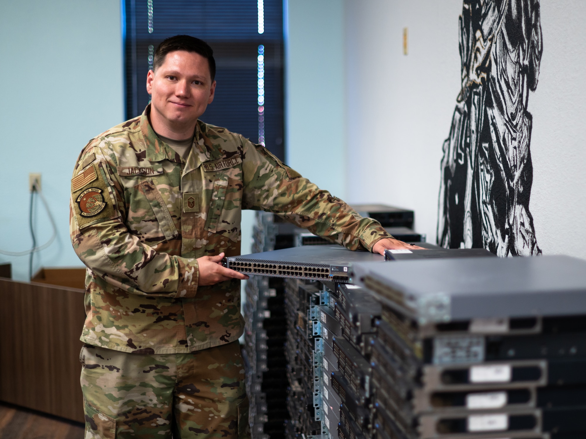 U.S. Air Force Master Sgt. Ivan Jackson, 7th Communications Squadron cyber transport systems section chief, holds a replaced network switch at Dyess Air Force Base, Texas, June 26, 2024. The 7th CS configured and installed roughly 400 pieces of network equipment to improve base cyber security and remove outdated technology. (U.S. Air Force photo by Airman 1st Class Jade M. Caldwell)