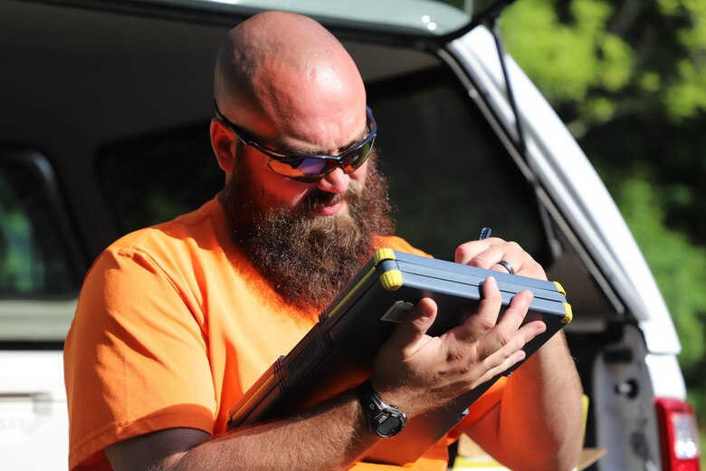 ERDC-CERL's Drew Miller taking notes on mold and corrosion progress within the Earth Covered Magazines (ECMs)