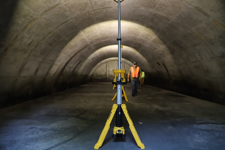 The ERDC-CERL team setting up lighting inside the Earth Covered Magazines (ECMs)