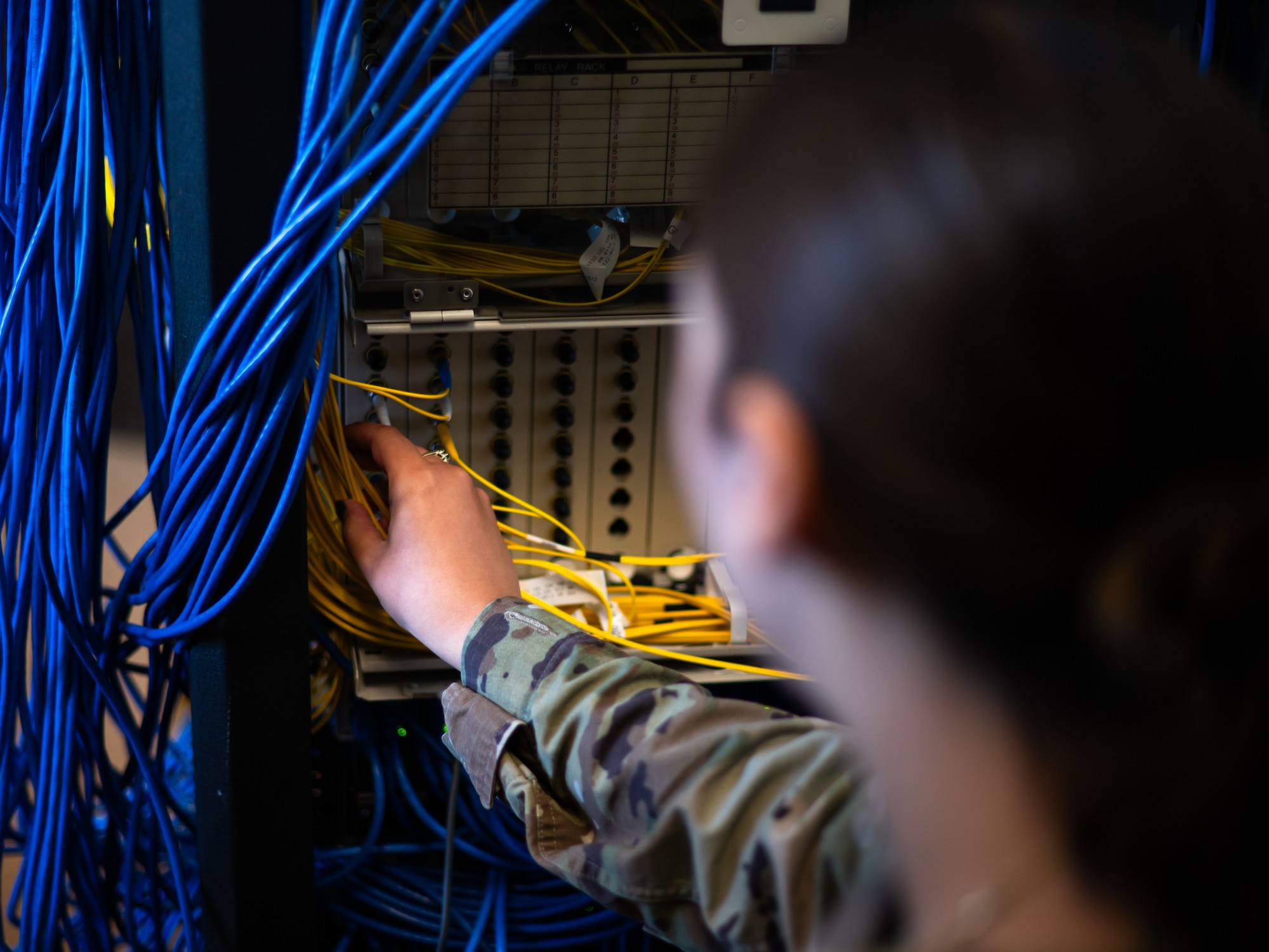 U.S. Air Force Senior Airman Isabella Romo, 7th Communications Squadron cyber defense operations technician, looks over equipment at Dyess Air Force Base, Texas, June 26, 2024. The 7th CS completed a network improvement that improved speed, bolstered defenses, and strengthened connection across the base. (U.S. Air Force photo by Airman 1st Class Jade M. Caldwell)