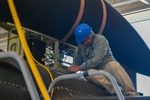 A 9th Maintenance Squadron data link maintainer helps to remove the Pylon Equipment Group (PEG) from a U-2 Dragon Lady on the flight line on Beale Air Force Base, California, April 8, 2024.