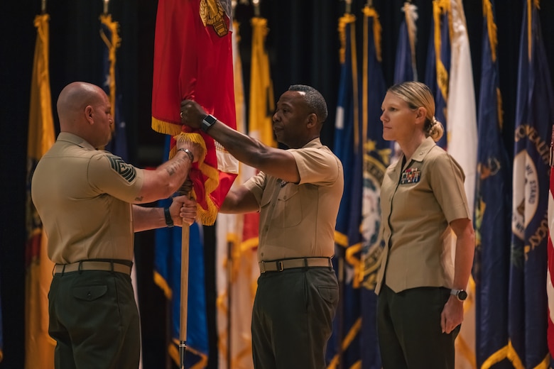 U.S. Marine Corps Col. Michael L. Brooks, the outgoing commanding officer of Marine Corps Base Quantico, center, receives the colors during a change of command ceremony on MCBQ Virginia, July 2, 2024. The passing of the colors is a tradition that signifies the transferring of responsibilities from the outgoing commanding officer to the oncoming. Col. Jenny Colegate relieved Brooks after serving as MCBQ as its commander for almost three years. “I refer to Marine Corps Base Quantico as a village, and I do that on purpose,” Brooks said. “It’s not all about the capabilities, but those [people in Quantico] who involve themselves; they insert themselves in to what needs to be done in support of the village.” (U.S. Marine Corps photo by Lance Cpl. Joaquin Dela Torre)