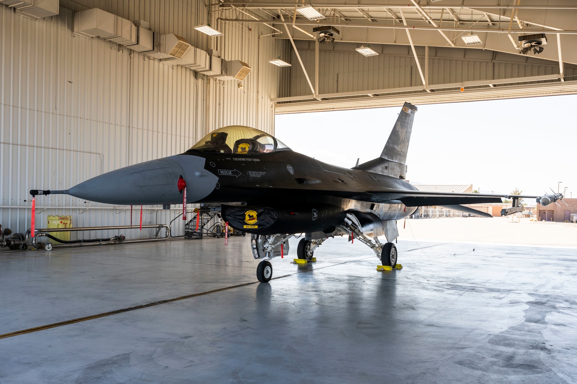 The 8th Fighter Squadron displays an F-16 Viper, painted to resemble an F-117 Nighthawk at Holloman Air Force Base, New Mexico, June 5, 2024. The 8th Fighter Squadron unveiled its new flagship, painted with a matte black color scheme that draws inspiration from the legendary F-117 Nighthawk stealth aircraft. (U.S. Air Force photo by Airman 1st Class Michelle Ferrari)