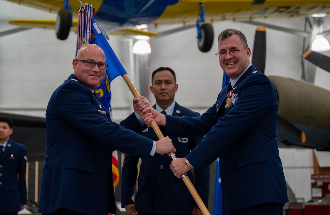 U.S. Air Force Col. Jamison Elder, 436th Medical Group commander, receives the guidon from Lt. Col. John Batka, outgoing 436th Operational Medical Readiness Squadron commander, during the 436th OMRS change of command ceremony at Dover Air Force Base, Delaware, July 2, 2024. The event saw Batka relinquish command to Lt. Col. Christopher Raimondi. (U.S. Air Force photo by Airman Liberty Matthews)
