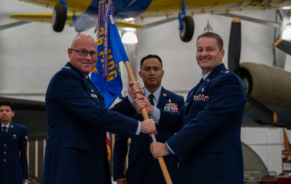 U.S. Air Force Col. Jamison Elder, 436th Medical Group commander, presents the guidon to Lt. Col. Christopher Raimondi, incoming 436th Operational Medical Readiness Squadron commander, during the 436th OMRS change of command ceremony at Dover Air Force Base, Delaware, July 2, 2024. The event saw Lt. Col. John Batka relinquish command to Raimondi. (U.S. Air Force photo by Airman Liberty Matthews)