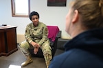 Chaplain (Maj.) Kimberly Hall, installation chaplain, talks with a military spouse in her office at the base chapel at Hanscom Air Force Base, Mass., March 8. (U.S. Air Force Photo by Jerry Saslav)