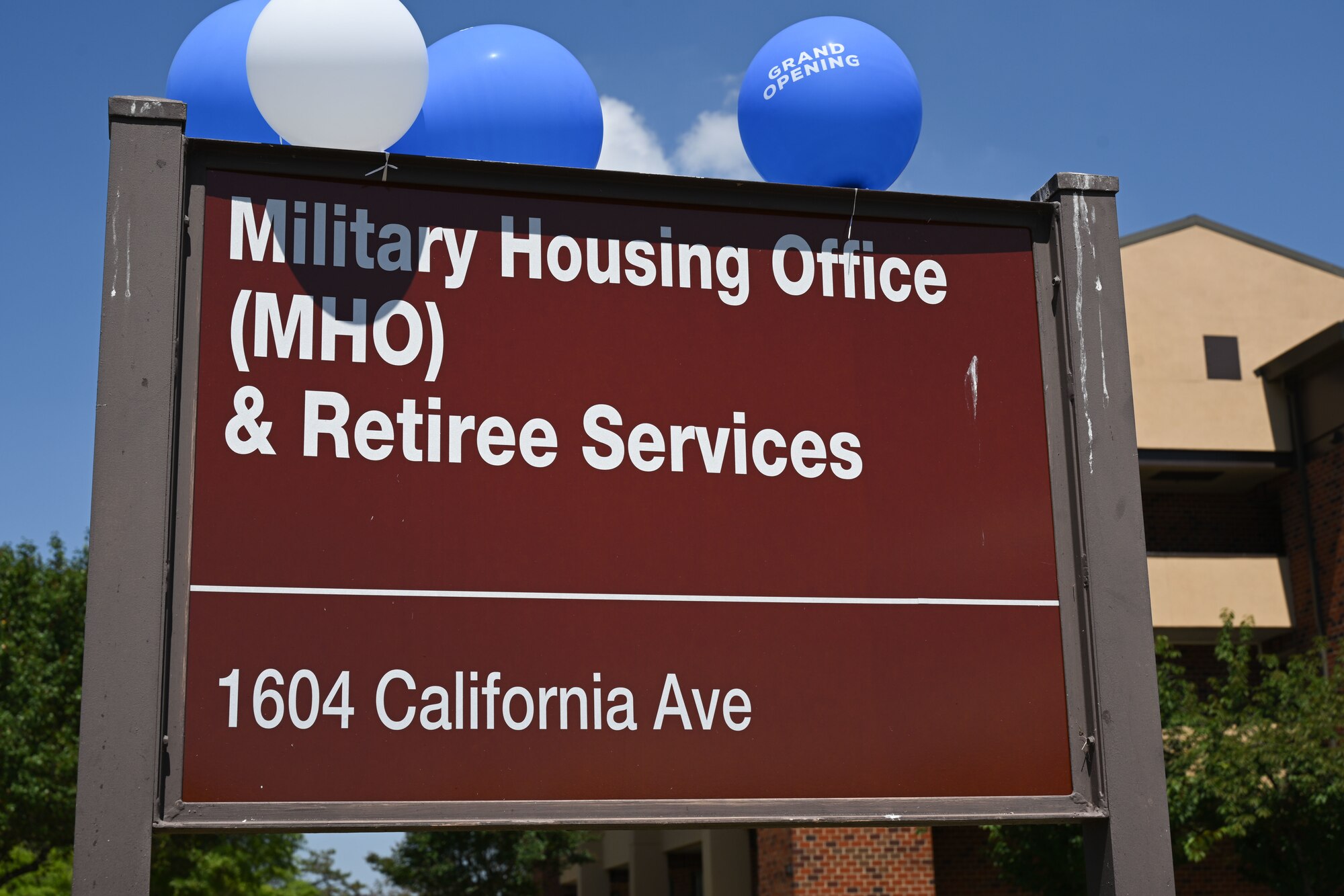 A sign that says Military Housing Office with the address.