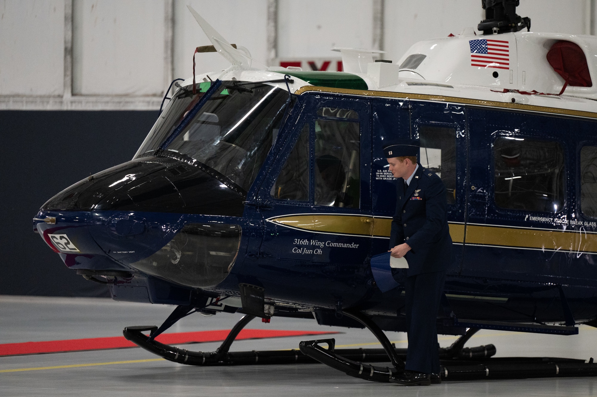 U.S. Air Force Capt. Jacob Darnell, assigned to the 1st Helicopter Squadron, unveils Col. Jun S. Oh’s name on an UN-1H Huey helicopter