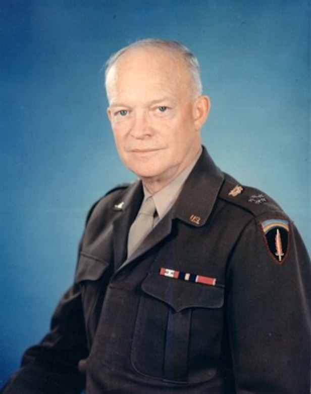 A man in a military uniform poses for the camera.