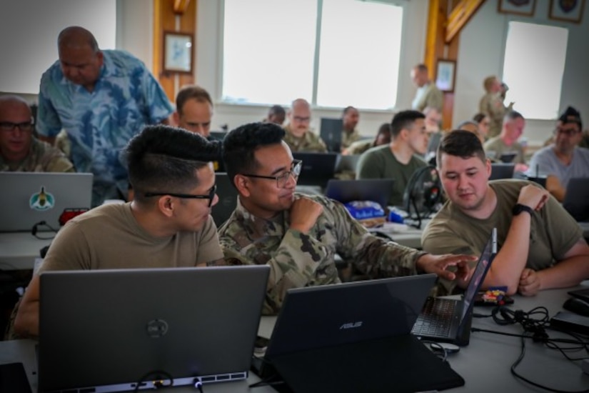Soldiers work on computers.